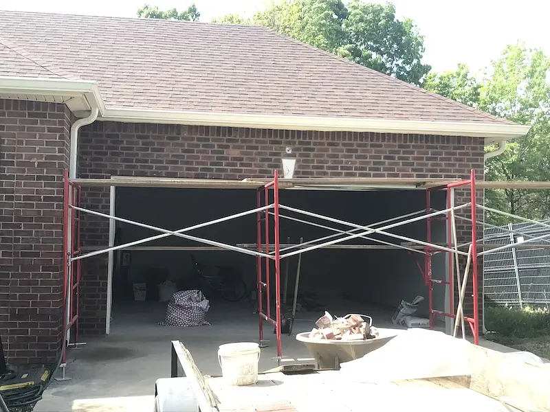 Scaffold set up for brick repair above a garage door